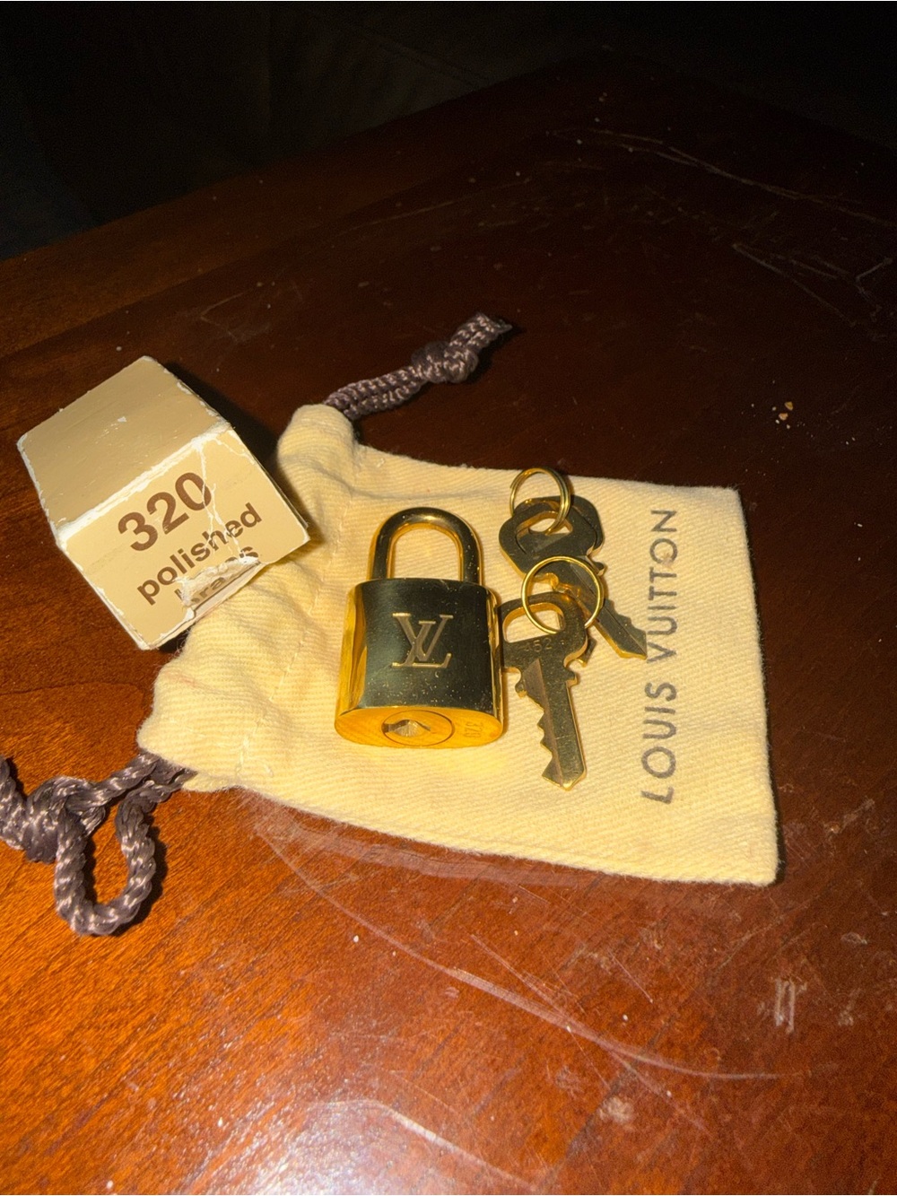 Louis Vuitton brass padlock, new with box and original dust bag.
